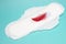 Big menstrual woman pad for hygiene in blood period. Menstruation sanitary pad and red feather, hygiene protection. Woman critical