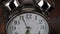 Big metallic clock close up 4k video. Time or showing time concept. Classic retro mechanical alarm clock