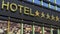 Big metallic glass hotel sign board with five golden stars