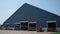 Big modern cow shed on agricultural rural ranch. Exterior livestock facility