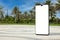 Big Modern Mobile Phone with Blank Screen as Template for Your Design in Empty City Street with Palm Trees. 3d Rendering