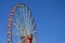 Big and modern multicolour ferris wheel on clean blue sky backgroun