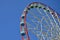 Big and modern multicolour ferris wheel on clean blue sky backgroun