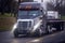 Big modern semi truck with bright headlight and flat bed