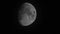 Big moon moves across night sky behind rare clouds. Telephoto lens shot