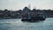 Big mosque in istanbul view from the bosphorus strait with boat passing by