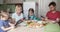 Big multi-generation family having dinner together, but everyone is texting in his own smartphone