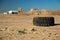 Big old tyre and rubbish lies in desert near Aqaba city in Jordan