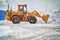 Big orange tractor removing snow