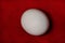 Big ostrich egg isolated on a red background. Organic fresh egg. Concept of healthy food. Ostrich egg as symbol of birth.