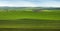 big panorama of geometric patchwork of gardens, agricultural lands, farmland in springtime