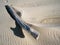 Big piece of drift wood on beach throwing a thumbs up shadow