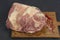 big piece of frosted mutton meat closeup photo on kitchen board