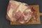 big piece of frosted mutton meat closeup photo on kitchen board