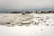 Big pieces of ice loosing and melting floes next to Port of Anchorage Small Boat Launch. Stevedore and cranes in the back.