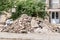 Big pile of cement concrete and dirt on the street in front of the residential building left as remains of the apartment renovatio