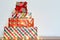 Big pile of colorful wrapped gift boxes isolated on wood table and white background. Mountain gifts.