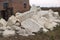 Big pile of large sand stones laying on the ground of construction site