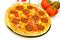 A big pizza with cheese,salami,tomatoes