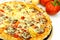 A big pizza with cheese,salami,tomatoes
