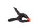 Big plastic black pressure clamp with red tips, isolated n white background