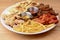 Big plate of beer snacks. Crispy fried chicken, french fries and different kinds of bread on white plate.