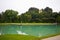 Big pond with azure water in the park of the palace Hellbrunn in