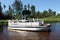 A big pontoon boat anchored in the river