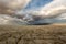 Big puffy clouds over a parched desert