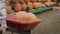 A big pumpkin is being driven in a wheelbarrow - buy a decoration for Halloween