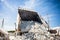 Big quarry truck unloads white limestone gravel to crushed stone quarry , limestone mining