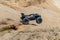 Big radio controlled buggy car driving fast and slipping on sand. RC toy moving fast on cross-terrain surface with dust