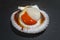 Big raw queen scallop with orange caviar in the shell on dark background. Luxury seafood and shellfish lat. Aequipecten