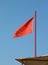 Big red flag to signal the danger and sky in background