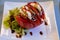 Big red french tomato served with fresh mozzarella cheese, basil pesto and creme balsamico as starter in restaurant in Provence,