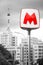 The big red letter M indicates the entrance to the underground metro on the background of the high-rise of the Stalin period