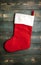 A big red Santa sock for a gift on white boards.