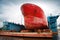 Big red tanker under repairing in floating dock