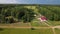 Big residential cottage with growing crops in the middle of forest and field