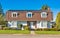 Big residential house on the street on sunny autumn day