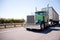 Big rig attractive green semi truck with bulk trailer