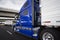 Big rig bright blue long haul semi truck transporting goods in r