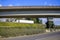 Big rig semi truck transporting cargo in dry van semi trailer running up on the concrete overpass road intersection