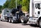 Big rig towing semi truck tow ather semi truck tractor on the road