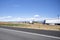 Big rigs semi trucks with different semi trailers standing on the highway exit road take a break according to the log book