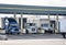 Big rigs small rigs and middle rigs semi trucks refuel at the gas station