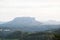 Big rock mountain in green forest in summer day