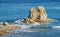 Big rocks in the sea surrounded by waves