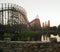 Big roller coaster in an amusement Park. High- speed ride on the rails at sunset.