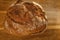 Big round appetizing fresh wholemeal bread with bran on wooden board, wheat, rye, multigrain bread topview, concept bakery